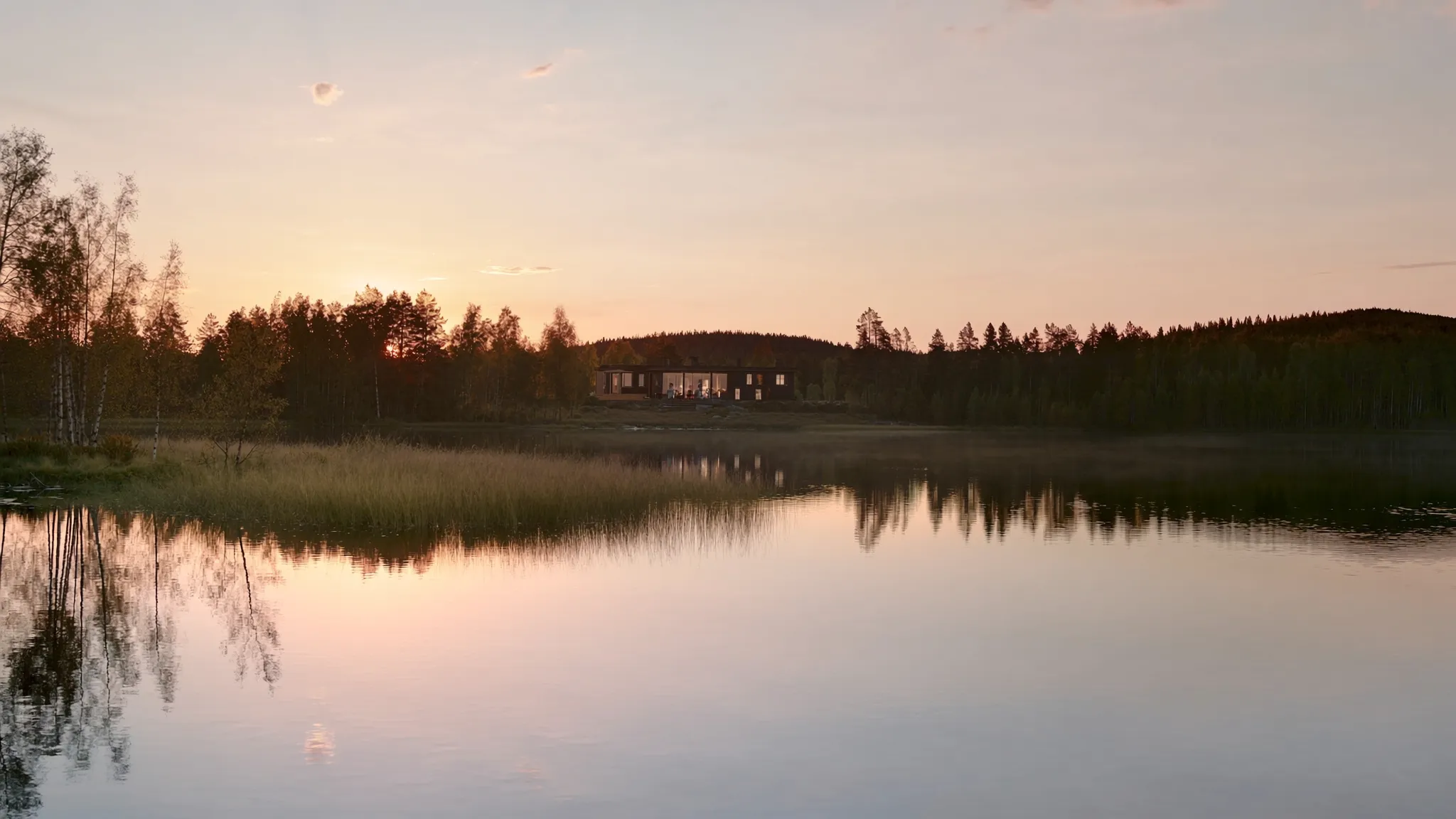 Midnight sun over a calm lake in Finnish Lapland